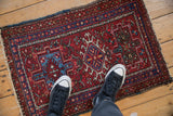 Vintage Karaja rug with central geometric medallion, brick red and sapphire blue tones.