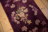 Close-up of Art Deco floral bouquet showing varied pile height on aubergine wool.