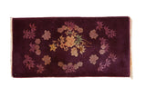 Antique Art Deco rug runner with gold floral bouquets scattered over a deep aubergine ground.