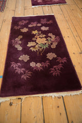 A pair of hand-knotted Art Deco runners in deep aubergine with dusty gold floral sprays.