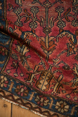 Soft, draped pile of a vintage Lilihan rug with geometric floral motifs in red, blue, and copper.