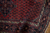 Fine wool pile showing the cherry red boteh field and navy turtle samovar design border.