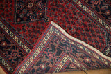 Fine hand-knotted construction visible on the back of a vintage Engelas rug's folded corner.