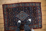 Overhead view showing the scale of a vintage Bibikabad rug with its deep indigo field and floral pattern.