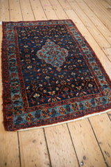 Angled perspective of a vintage Bibikabad rug showing its blue medallion and indigo field.
