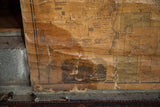 Peeling canvas and water damage revealing the historic character of a pre-Civil War wall map.