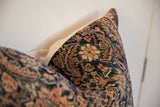 Vintage rug fragment pillow texture with intricate Persian Fereghan navy and saffron pattern.