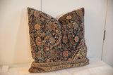 Traditional navy, ivory, and coral patterns on vintage Fereghan pillow's lower border.