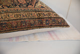 Intricate hand-knotted Persian rug fragment pillow pattern, rust, navy, ivory.