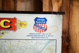 Union Pacific shield logo detail on vintage railroad map, showing torn edge and age.