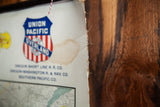 Frayed top edge and brown stain on antique Union Pacific railroad canvas map.