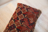 Antique Turkmen hand-knotted pillow, rich red, blue, and sand tribal geometric pattern.