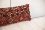 Side view of vintage hand-knotted Turkmen pillow, highlighting geometric border pattern.