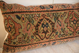 Textured antique Persian Fereghan rug pillow fragment with rust, olive, indigo, and saffron patterns.