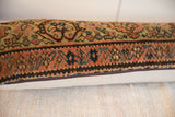 Vintage hand-knotted rug fragment pillow side view, showing woven texture and zipper.