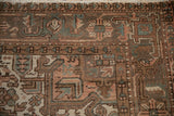 Distressed Mehrivan carpet detail: geometric, stylized floral patterns, dusty blush, seafoam green.