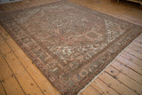 Distressed Mehrivan carpet featuring geometric medallions, floral motifs, and time-softened pastel tones.