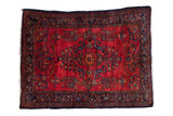 Vintage Persian Lilihan rug with fine curvilinear floral bouquets on a cherry red field with a navy border.