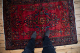 Overhead view of the vintage Lilihan rug's lustrous wool and curvilinear floral patterns.