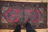 Scale and texture of a vintage Mehriban rug with a stepped medallion in raspberry red and blue.