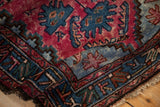Detail of a vintage Mehriban rug's soft pile and period-correct color halo in raspberry red and blue.