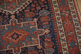 Antique Karaja rug detail: geometric pawn motif, dark blue, brick red, ivory, and pile wear.