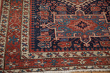 Antique Karaja rug corner, showing geometric madder red, dark blue, ivory borders and fringe.