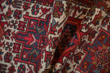 Textured hand-knotted pile of vintage Karaja runner, with geometric red, ivory, and blue motifs.