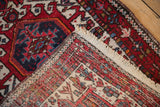 Vintage Karaja runner corner revealing cream fringe and detailed hand-knotted foundation.