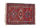 Vintage Karaja rug with a geometric triple medallion in brick red, denim blue, and ivory.
