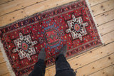 Overhead perspective of a vintage Karaja rug runner with brick red and blue geometric medallions.