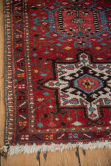 Corner detail of a vintage Karaja rug showing the intact side selvage and geometric medallion.