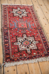 Vintage Karaja runner with repeating geometric medallions, viewed from an angle.