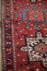 Side detail of a vintage Karaja rug showing the geometric border, low pile, and intact selvage.
