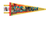 Detailed graphics inside 'LAS VEGAS' letters on a yellow felt pennant showing famous hotels.