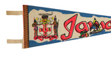 Left side of vintage Jamaica pennant with brown binding, hanging loops, and detailed coat of arms.