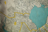 Detailed view of the 1930s Portland, Maine map showing blue Back Cove and water damage.