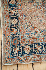 Intricate cypress tree border of a fine antique Tabriz rug in navy blue, rust, and ivory.