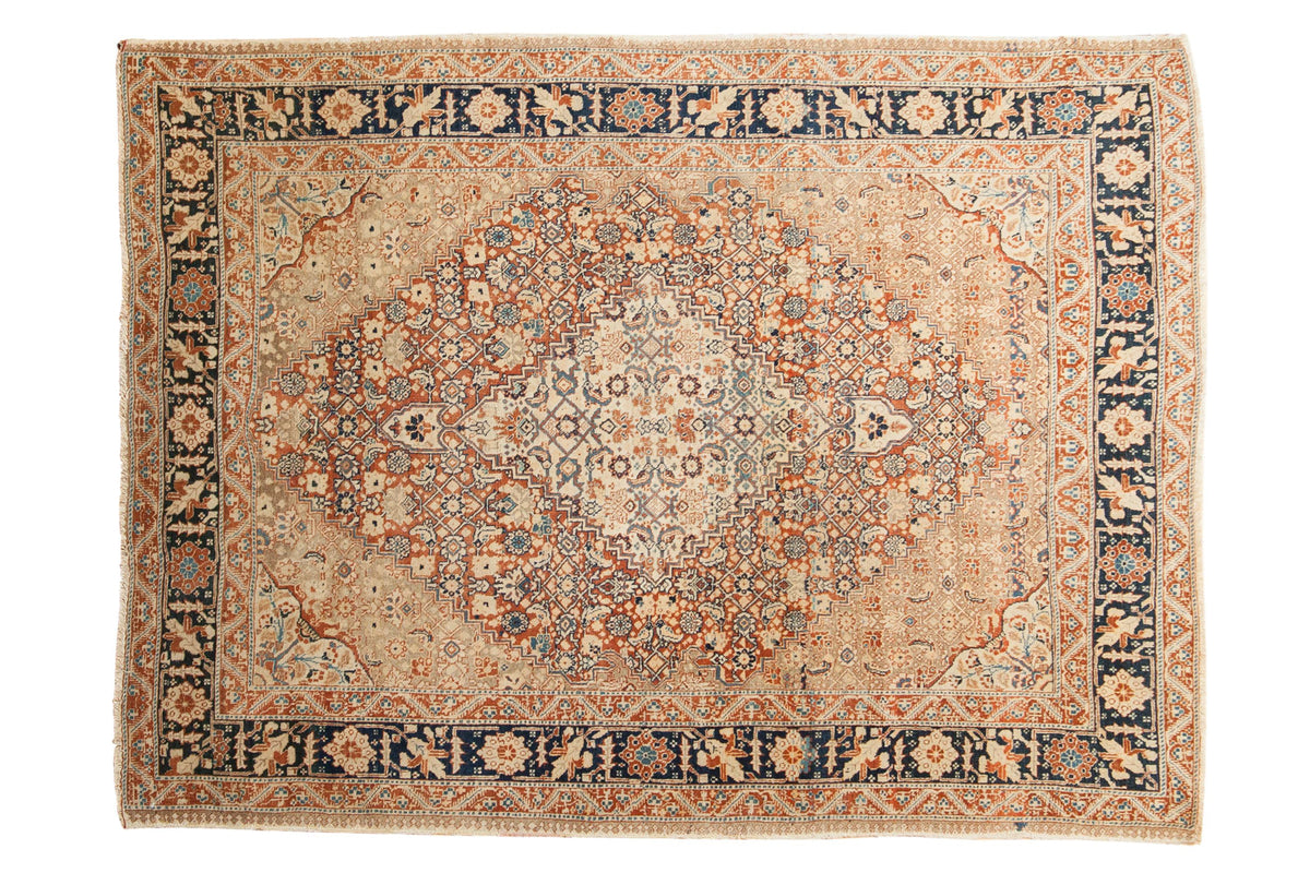 Fine antique Tabriz rug with an intricate medallion, beige field, and navy cypress tree border.