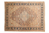 Fine antique Tabriz rug with an intricate medallion, beige field, and navy cypress tree border.