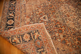 Folded corner of an antique Tabriz rug revealing the fine weave and cypress tree border.