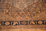 Cypress tree motifs on a navy border contrast with the antique Tabriz rug's intricate field.