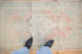 A top-down perspective on the soft, even wear of a distressed vintage Oushak rug.