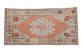 Vintage distressed Oushak runner with central medallion, geometric border, terracotta and silver.