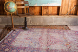 Vintage Kerman rug corner, showcasing light blue, pink, gold, and ivory floral patterns with desirable wear.