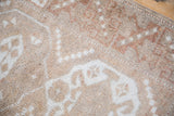 Distressed Melas rug pile, with even wear and coffee brown, ivory serrated patterns.