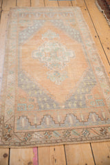 Distressed Oushak rug corner with stepped niche and meandering border design.