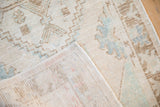 Distressed vintage Oushak rug pile with geometric floral patterns and visible hand-knotted foundation.
