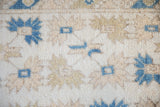 Shaggy ivory pile of vintage Dosemealti rug featuring indigo and olive quatrefoil florals.