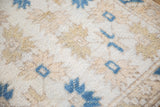 Vintage Dosemealti rug detail: shaggy ivory pile with indigo blue quatrefoil floral patterns.